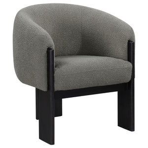 Bring updated style and sophistication to your living room or den with a modern accent armchair. It boasts an inviting rounded silhouette with sloping arms. Three legs in a black finish add a sculptural sensibility. Textured boucle upholstery creates rich