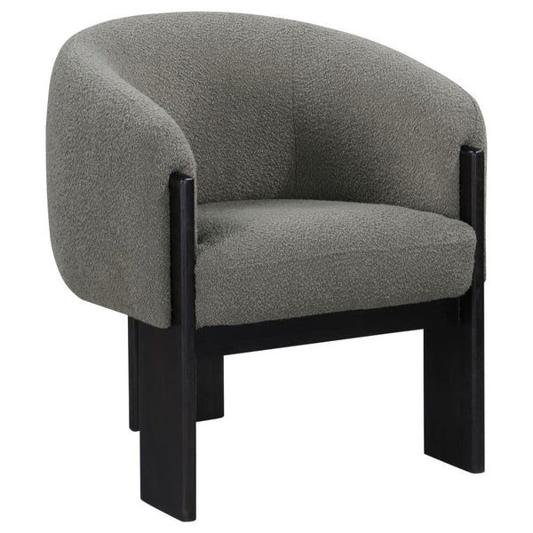 Bring updated style and sophistication to your living room or den with a modern accent armchair. It boasts an inviting rounded silhouette with sloping arms. Three legs in a black finish add a sculptural sensibility. Textured boucle upholstery creates rich