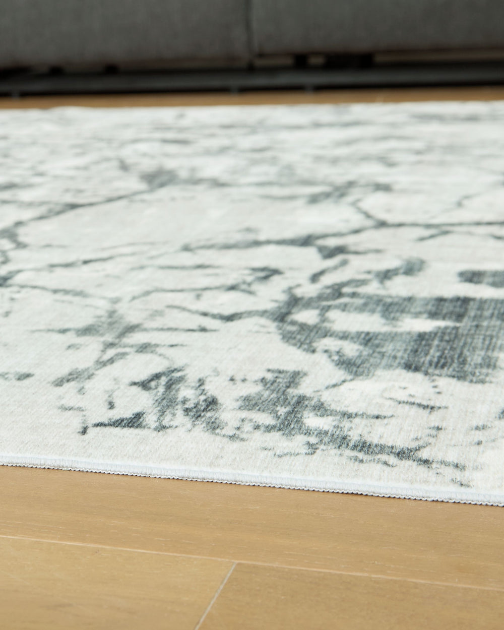 Make a statement that effortlessly complements your modern sensibilities. This rug adds an intentionally curated feel underfoot, with versatile shades of gray forming an intriguing abstract design. Crafted with comfort and convenience in mind, this soft f