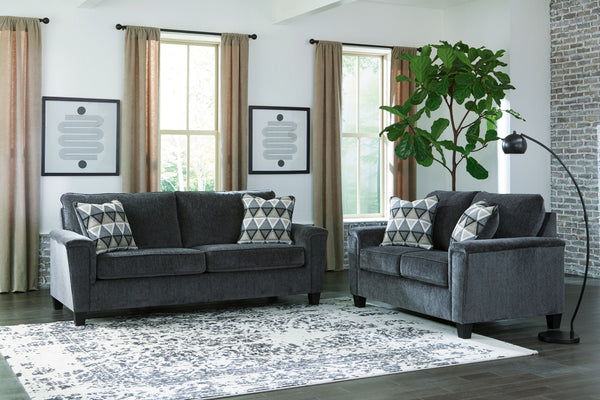 Everyone can have the best seat in the house with this sofa and loveseat. An indulgent choice with deep seats crafted for cloud-like softness, this set is the ideal merger of modern flair and classic staying power. <h4><b>Abinger - Smoke - Sofa</b></h4> <