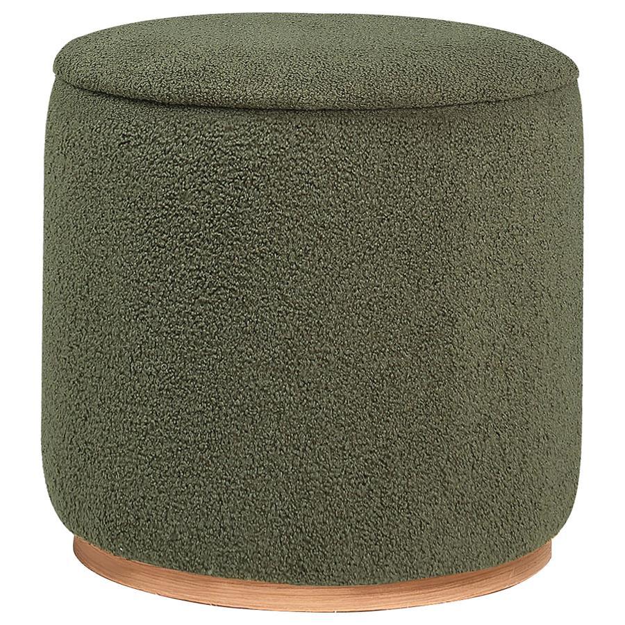 Add a touch of playful luxury to your living space with this round upholstered ottoman, swathed in sumptuous faux sheepskin that invites you to touch. Resting on a metal base that-'s been expertly finished to emulate the warm, natural allure of wood grain