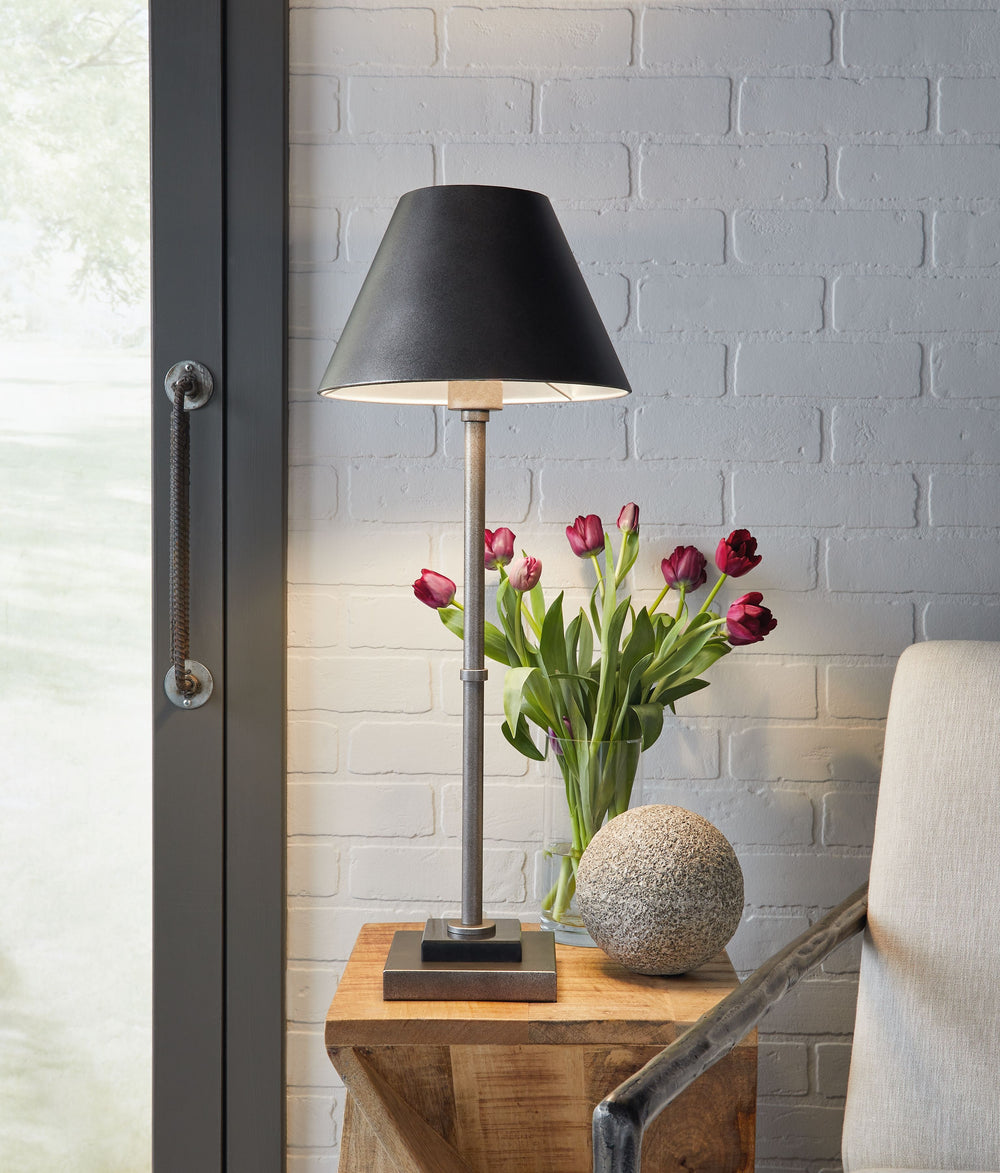 Both stylish and functional, this table lamp blends mid-century design with sleek contemporary finishes to illuminate your space in a cool, minimalistic way. The antiqued pewter-tone finish and black marble lend a richly understated touch. Whether on a ma
