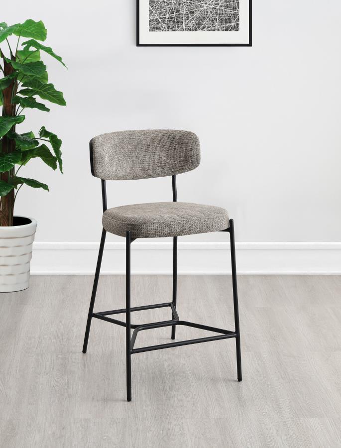 Introduce comfort and style with a set of two contemporary counter stools for your kitchen. Each features a black finish metal frame, offering streamlined character with slim structure and geometric details. Light, neutral upholstery covers foam cushions,