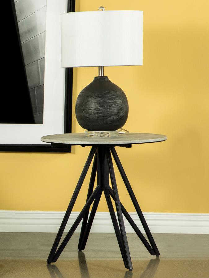 Industrial elements and sleek modern lines bring forth this modern end table. A metal butterfly-like base design of open and flared hairpin style legs in a gunmetal finish offer a striking visual interest to the furniture piece and the room in which is re