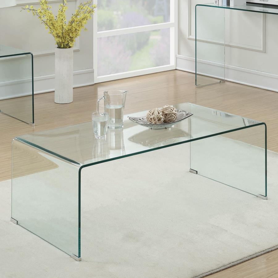 This rectangular coffee table is crafted from tempered bent glass, blending modern elegance with superior durability. Its seamless one-piece design eliminates the need for assembly, offering immediate convenience and use. The smooth curved edges enhance s