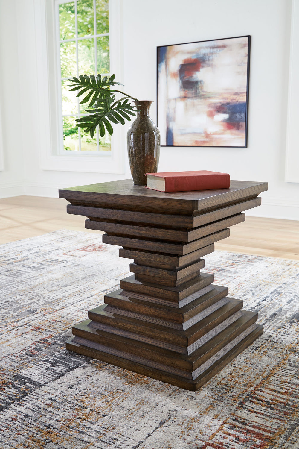 A statement-making table? Yes, please. The distinctive silhouette of this end table is sure to captivate lovers of contemporary design. Featuring head-turning architectural geometry and a rich, inviting warm brown finish, this piece is ready to take your 