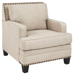 A case of contemporary and classic style influences coming together in a beautiful way, this chair in beige brings a fresh perspective to modern farmhouse living. Distinctive elements include t-cushioning that wraps around setback track arms, nailhead tri