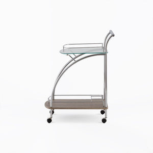  the Badin serving cart has a floating top glass shelf for immediate access and a lower gallery shelf to keep your additional items safe from falling out. Finished in chrome and rolling on four plastic casters