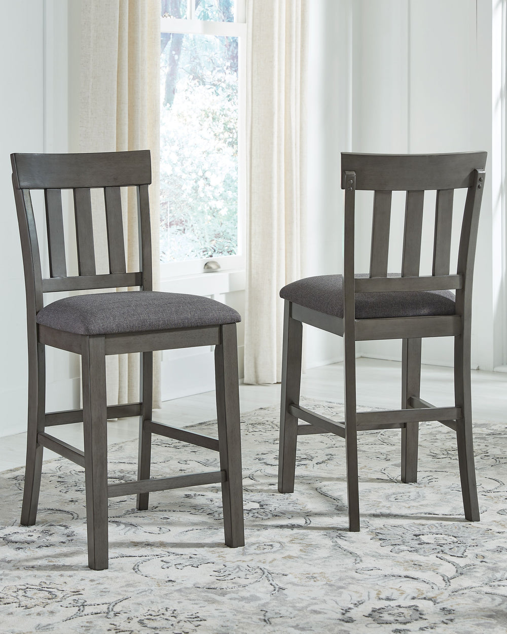 Cool and on-trend. This upholstered barstool sports a two-tone gray look for a contemporary-yet-casual feel. The cushioned foam seat in a gray textural fabric pairs seamlessly with the antiqued gray finish, while the contoured comb-back design adds a dash