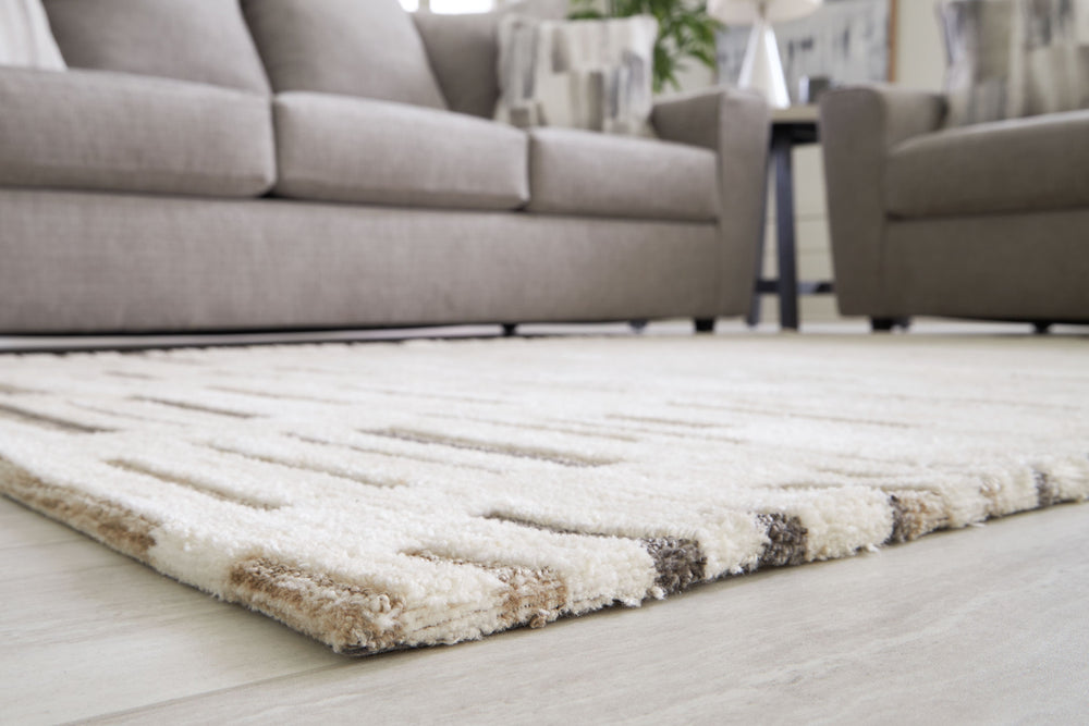 Need a centerpiece for your contemporary space? This area rug, with its high-low stripe design, captures the essence of designer styling. And its durable materials will endure the rigors of daily wear and tear. Set the scene with this rug for an unforgett