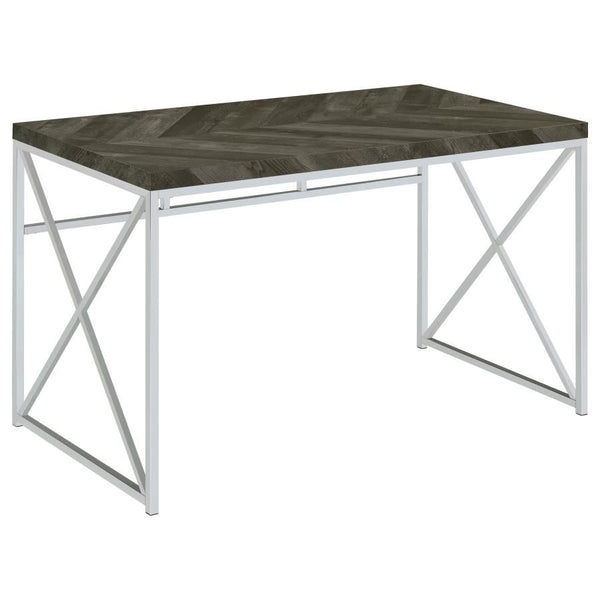 Add modern sophistication to your workspace with this writing desk, featuring a sleek rustic grey herringbone finish that blends contemporary and industrial styles. Its sturdy metal frame, finished in polished chrome, provides a geometric aesthetic with b