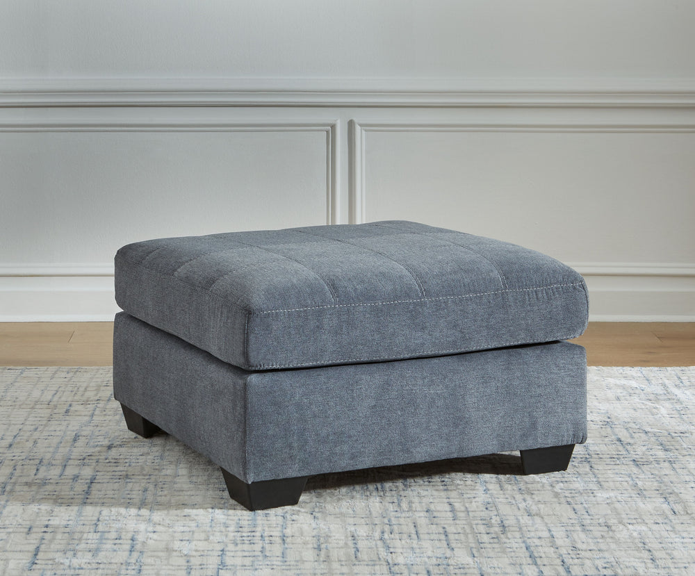 This oversized accent ottoman takes a homey approach to high style. Its denim-inspired fabric has classic versatility, while a contemporary silhouette and stitched details keep the look totally on trend. And you can count on comfortâ€”the ottoman-'s large