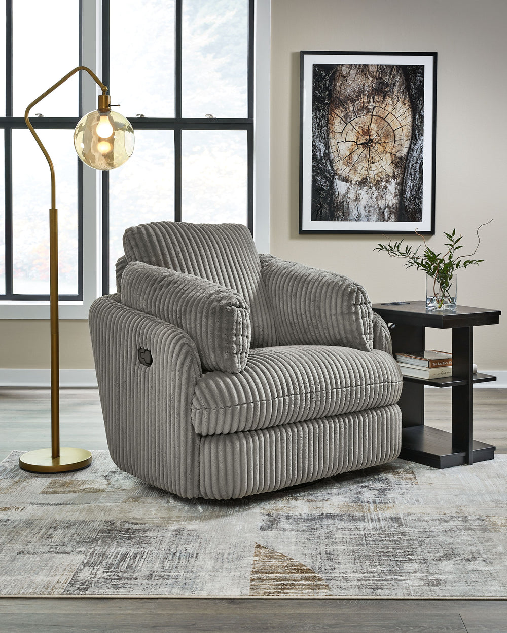 Like a warm hug, this recliner envelops you in comfort with its barrel shape and soft cord upholstery. It reclines, glides, and swivels to cater to your every need. This chair also features posh bolster pillows and cleverly designed storage. Unwind and cu