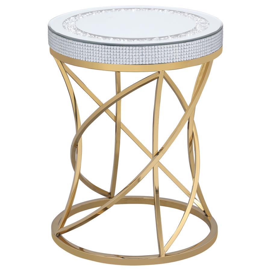 Bring glamorous sophistication to your living space with this contemporary round end table. The mirrored tabletop, framed by a jeweled edge and inset with acrylic crystals, adds an alluring touch. The sculpted base, crafted from stainless steel with a gol