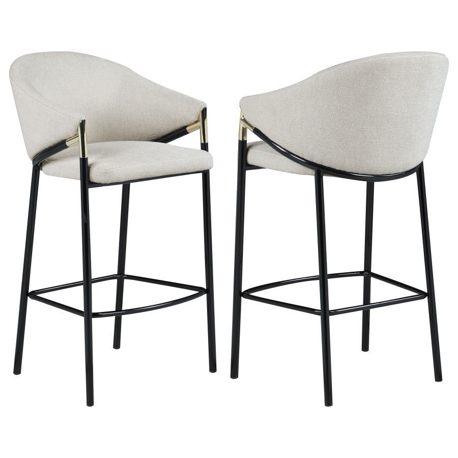 This pair of two stools offer a Hollywood regency look. With a tall and sleek design, the legs come in a glossy black finish that lends to many color palettes and offers a handsome look. Each stool has a cushioned seat, wrapped in a linen-like fabric that