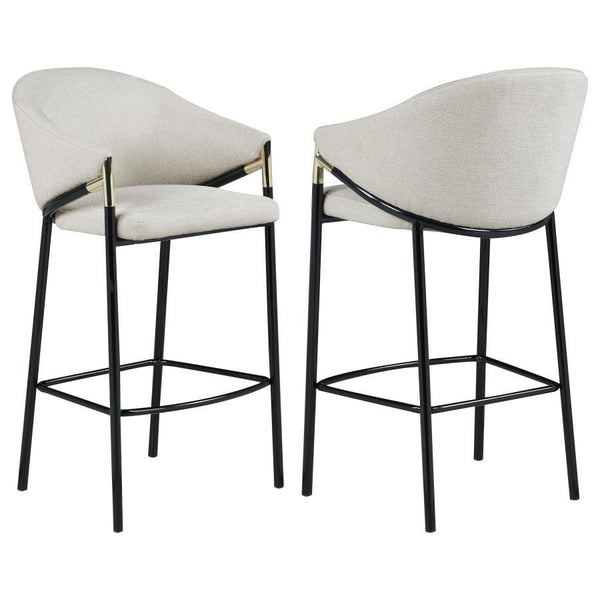 This pair of two stools offer a Hollywood regency look. With a tall and sleek design, the legs come in a glossy black finish that lends to many color palettes and offers a handsome look. Each stool has a cushioned seat, wrapped in a linen-like fabric that