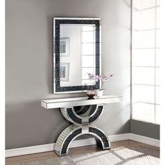 The gorgeous Noor mirrored console table is a great addition to your foyer or living room. This table is a sight with its rectangular mirror top with a unique geometric base that is a combination of regular mirror and black decorative crystal center. Shin