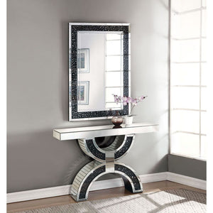 The gorgeous Noor mirrored console table is a great addition to your foyer or living room. This table is a sight with its rectangular mirror top with a unique geometric base that is a combination of regular mirror and black decorative crystal center. Shin
