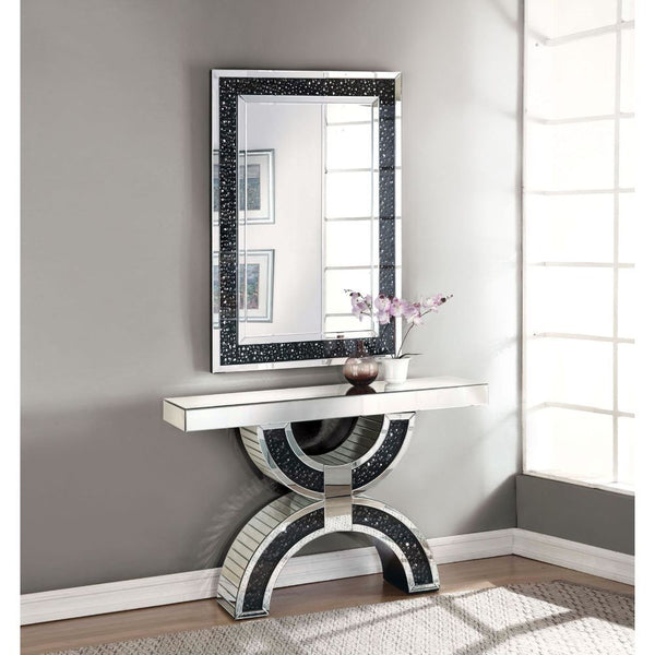 The gorgeous Noor mirrored console table is a great addition to your foyer or living room. This table is a sight with its rectangular mirror top with a unique geometric base that is a combination of regular mirror and black decorative crystal center. Shin