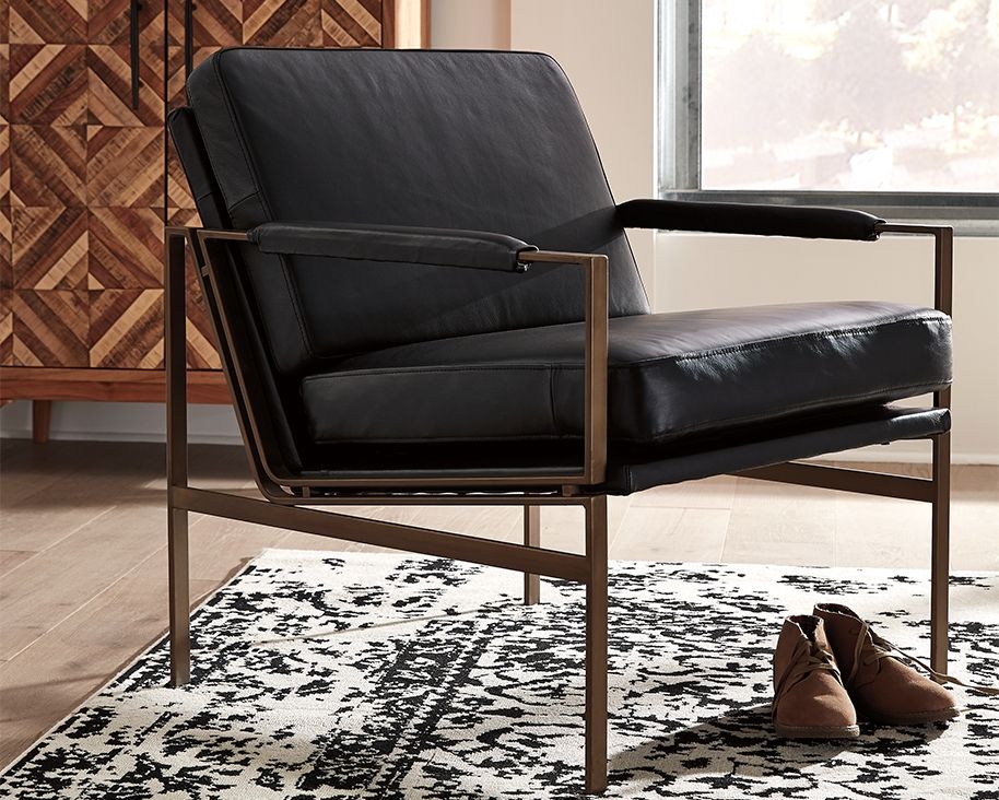 This accent chair has an ultra-modern vibe and indulgent feel. Its metal frame is a chic complement to black leather seating. With its nickel-tone finish and urban industrial style, this accent chair impresses with high-end looks priced to entice.<br><br>