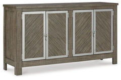 The use of mixed materials on this urban-inspired double buffet makes it a true statement piece. Made of wood with metal accents, this buffet features two spacious cabinets, each with an adjustable shelf and metal framed doors with trend-right window latc