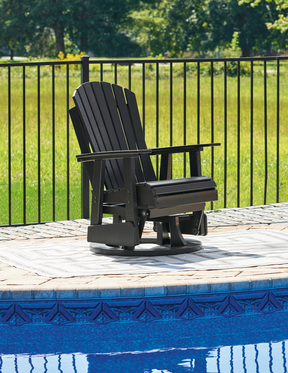 Drift away from everyday worries and into outdoor bliss with this swivel glider chair. Dressed in a smart black, the Adirondack-inspired design has a contemporary feel. It weathers sunny summer days and cozy winter nights with durable MEGA-TUFFÂ® HDPE mat