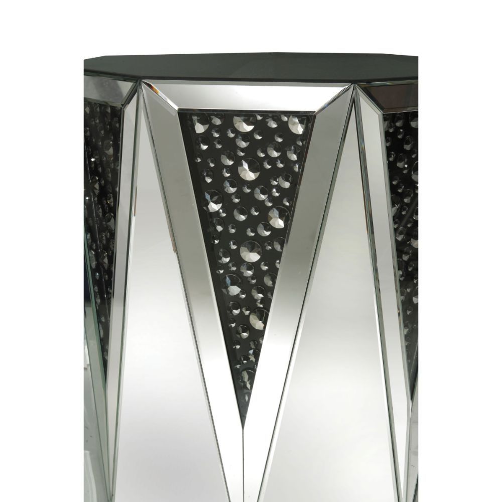The Noor mirrored occasional table will add a modern glam style to your living room. This drum table features a sleek and unique style with its octagonal top, triangular base, and crystal inserts. Add this coffee table to any room to add to add style and 