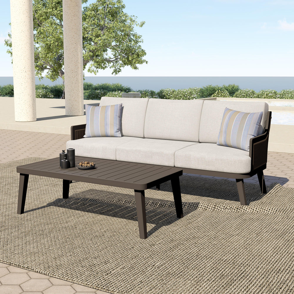 The Genova 2-Piece Patio Set, featuring a spacious patio sofa and a stylish coffee table, effortlessly combines durability, comfort, and modern sophistication for any outdoor space. Built with durable aluminum frames and a baked-on powder coat finish, thi