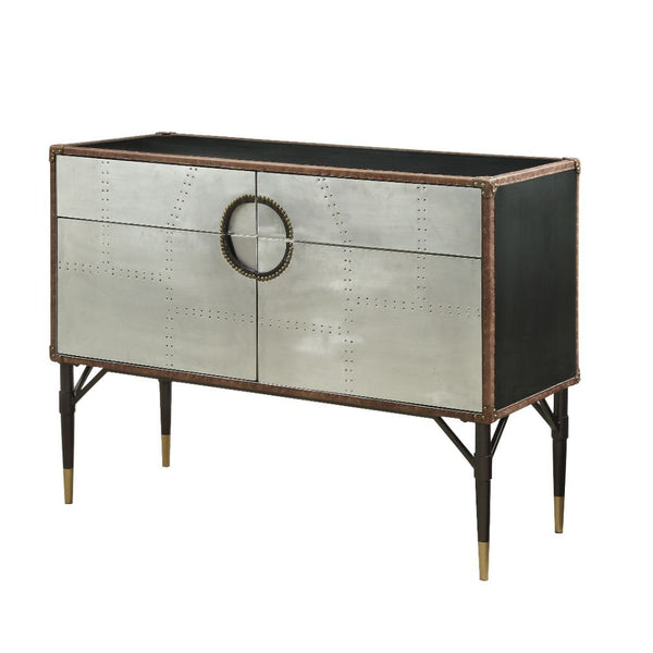 With its riveted patchwork of polished aluminum, the Brancaster console table is inspired by mid-20th-century air travel. This unique console piece features ample storage with two drawers and cabinet space with two doors, all supported by tapered metal le