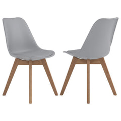 Elevate your dining space with this sleek, mid-century modern side chair. Featuring a smooth, grey faux leather seat and angled oak wood legs, it delivers style and durability. The padded shell offers lasting comfort, while the heat- and stress-resistant 