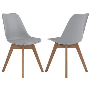 Elevate your dining space with this sleek, mid-century modern side chair. Featuring a smooth, grey faux leather seat and angled oak wood legs, it delivers style and durability. The padded shell offers lasting comfort, while the heat- and stress-resistant 