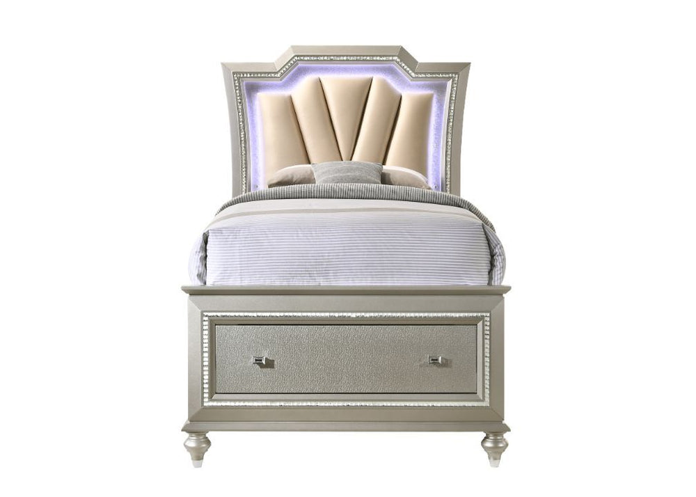 The Kaitlyn bed provides a commanding presence in any master bedroom. This contemporary storage bed in champagne finish features a diagonal channeled tufted padded headboard and a low-profile footboard with storage drawers. Expertly crafted with a glam lo