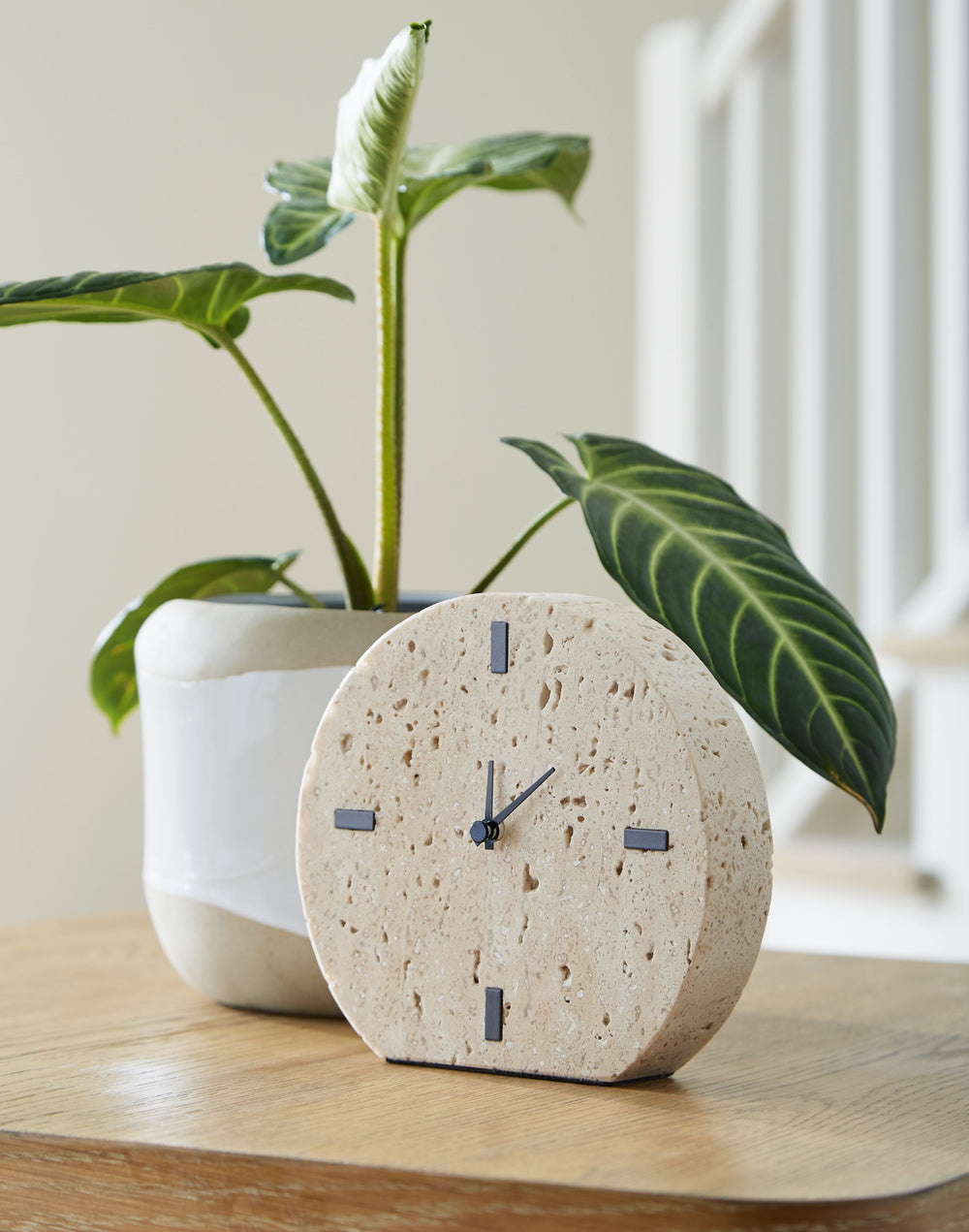 Take note of the time in contemporary style. Crafted from beige travertine, this clock is sure to lend minimalist flair to shelves and tabletops. Black accents provide a dramatic contrast to the earthy sensibility of the simple-yet-sophisticated timepiece