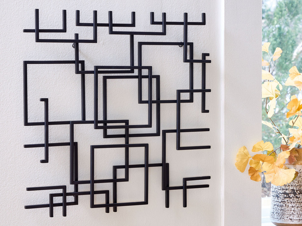 Intriguing with an intricate metal design, this wall sculpture is sure to add an artistic note to your modern interior. Its abstract style incorporates squares overlapping with fragmented lines in a black finish, for a look thatâ€™s simply amazing. A hidd