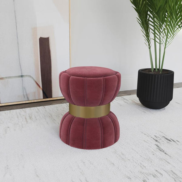  with a wide band highlighting in a bright gold finish. The round ottoman is a compact addition