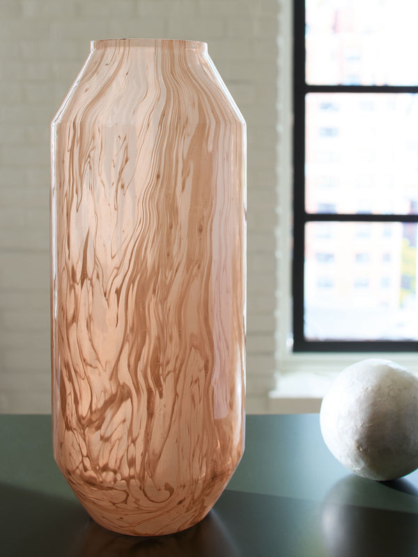  this vase has a chic sensibility that elevates your decor. Its contemporary silhouette is topped in a blush pink finish and flowing swirls