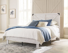 Give provincial a new meaning with the chic look of this queen crossbuck panel platform bed. The worn whitewash distressed finish keeps this piece light and fresh while the warm pewter-tone hardware adds an industrial touch. The panel headboard with cross