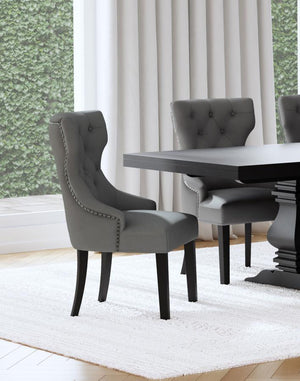  inviting dining room space with a modern button tufted dining chair. It pairs a classic wingback profile with a gentle curvature