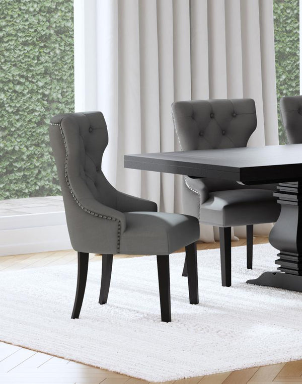  inviting dining room space with a modern button tufted dining chair. It pairs a classic wingback profile with a gentle curvature