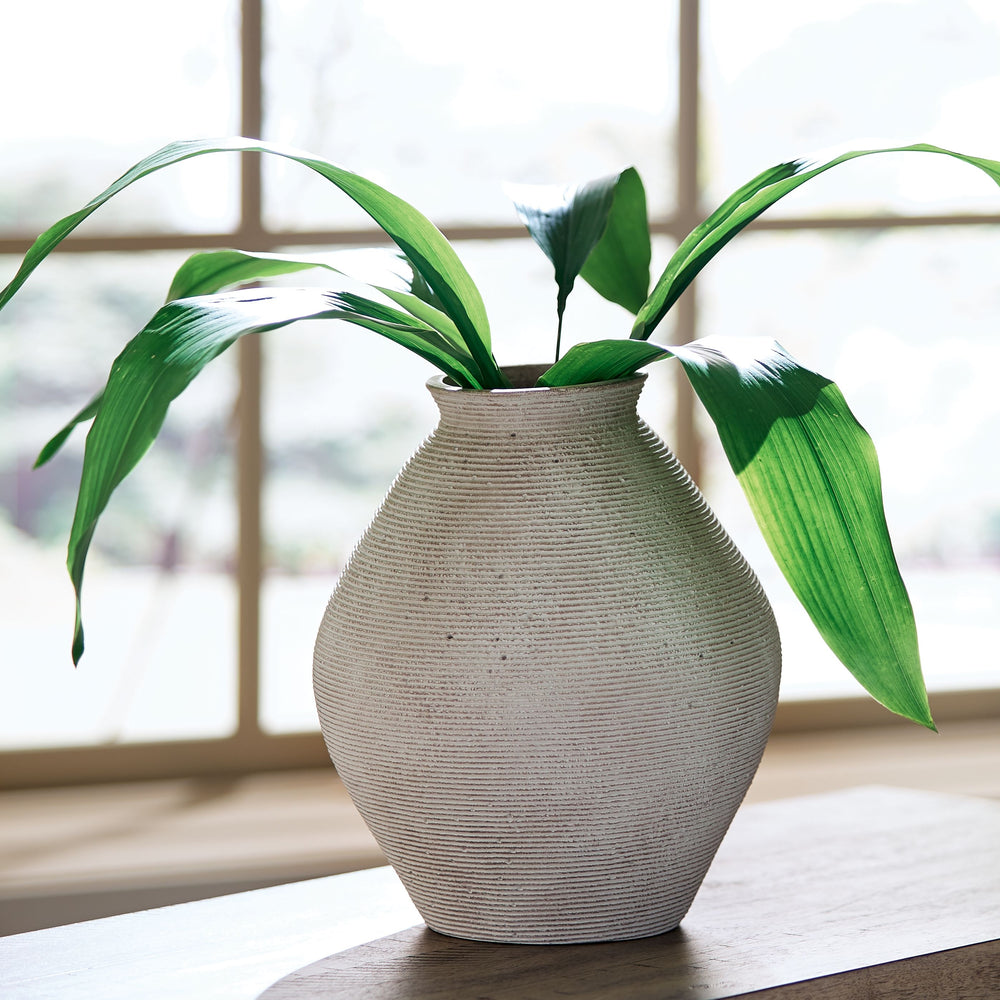 Ribbed textural rings give this vase a wonderful artisanal quality. An antiqued tan finish catches the eye, drawing attention to this elegantly fresh centerpiece.<br/><br/><b>Product Features</b><ul><li>Made of polyresin</li><li>Antiqued tan finish</li><l