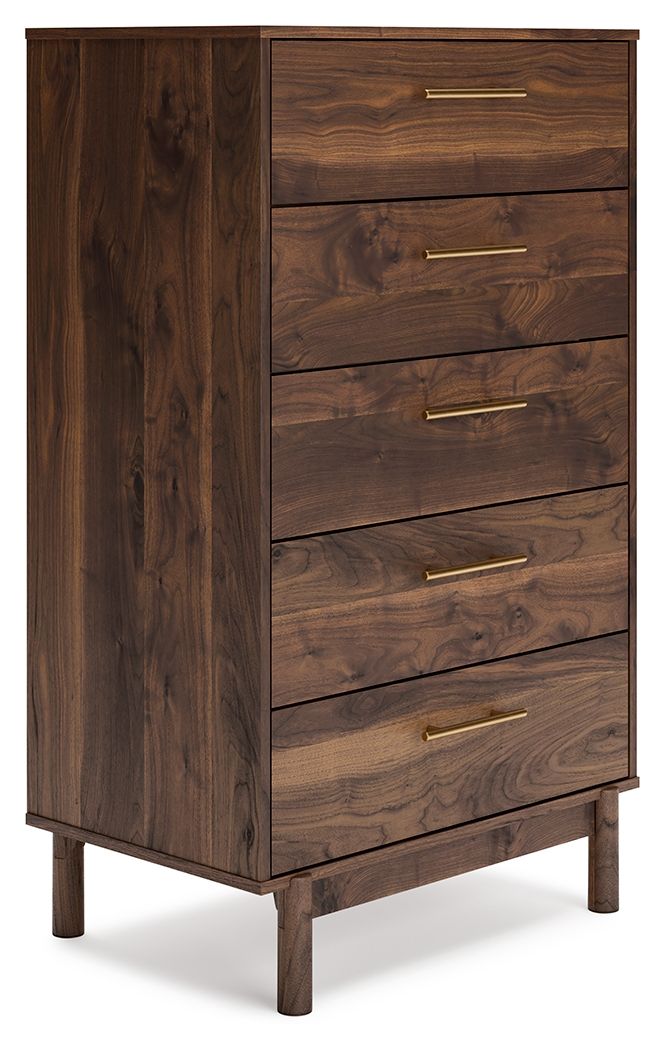 At the intersection of industrial cool and chic sophistication, youâ€™ll find this chest of drawers. With a rich brown finish over replicated walnut wood grain, paired with burnished goldtone handles, it offers an authentic touch that plays well any way y