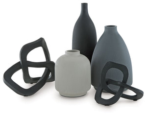 Give your space a contemporary vibe and lots of variety with this accessory set. These vases and sculptures, with a medley of neutral hues that work in beautiful harmony, mix well with your existing decor. Displayed in a group or individually, their uniqu