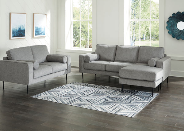 Simple comfort meets modern function in this living room set. An apt addition to apartments and other small spaces, the slim-profiled piece welcomes you with its cozy character. A subtle chevron pattern on the cushions refresh the classic neutral hue, ele