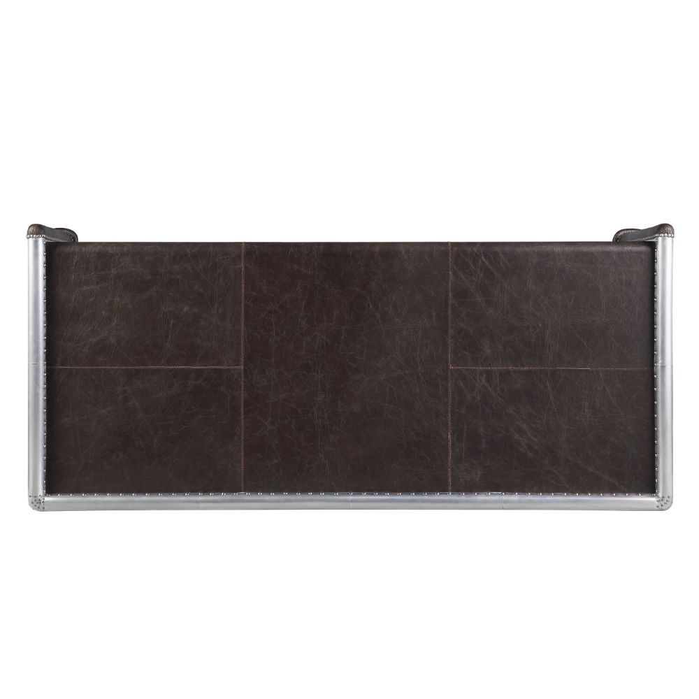 The Brancaster Aluminum Desk-'s modern look and industrial styling are evident in distress chocolate top grain leather top, aluminum over plywood construction, and exposed rivets that form a patchwork over the frame. A brilliant addition to your workspace