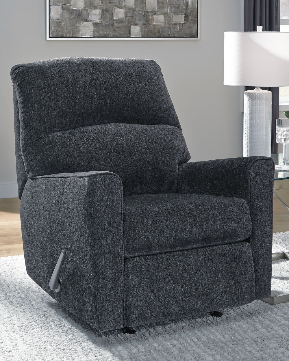 If style is the question, then this rocker recliner is the answer. Its clean-lined profile is beautifully contemporary. Plush chenille fabric and plump cushioning make it so easy to comfortably kick up your heels. And the recliner-'s richly neutral hue co