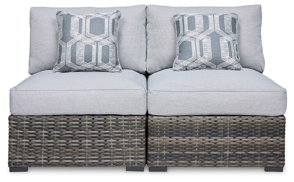 This cool, casual outdoor chair will raise the comfort level and visual appeal of your outdoor living space. Made of handwoven wicker in neutral tones of light and dark gray, the armless chair blends beautifully into your lanai or pool and patio area with