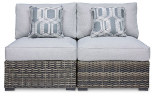 This cool, casual outdoor chair will raise the comfort level and visual appeal of your outdoor living space. Made of handwoven wicker in neutral tones of light and dark gray, the armless chair blends beautifully into your lanai or pool and patio area with