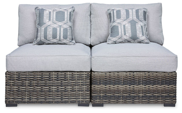 This cool, casual outdoor chair will raise the comfort level and visual appeal of your outdoor living space. Made of handwoven wicker in neutral tones of light and dark gray, the armless chair blends beautifully into your lanai or pool and patio area with