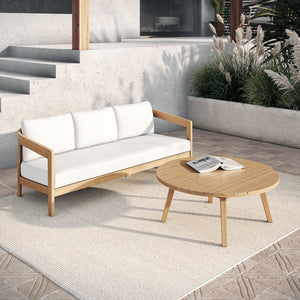  featuring a spacious outdoor sofa with plush white cushions and a matching coffee table