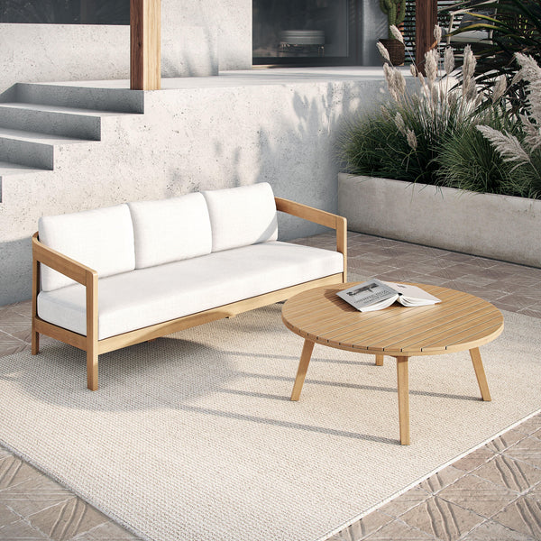  featuring a spacious outdoor sofa with plush white cushions and a matching coffee table